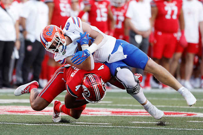 Aug 31, 2023; Salt Lake City, Utah, USA; Florida Gators tight end Jonathan Odom (87) is taken down by Utah Utes cornerback JaTravis Broughton (4) in the first half at Rice-Eccles Stadium. Mandatory Credit: Jeff Swinger-USA TODAY Sports